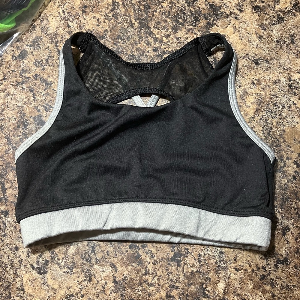 black sports bra with silver band with mesh on tue back
